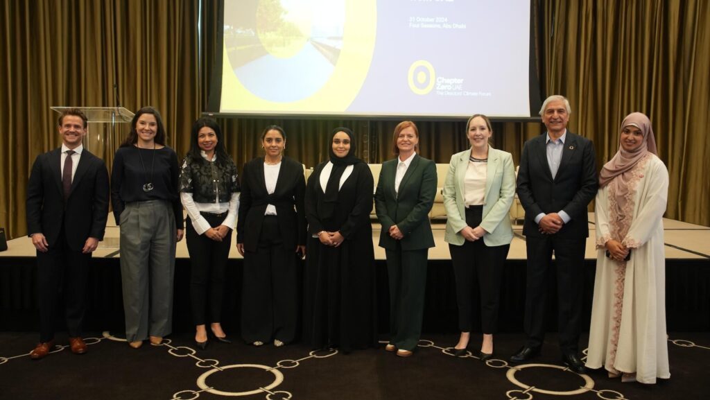 Chapter Zero UAE Steering Committee at the Chapter Zero UAE launch, in front of the stage and projector. From L-R: Greg Dearden, Aurora50; Cintia Kulzer Sacilotto, UAE University; Naven Rahman, HSBC; Zainab Aziz, UICCA; Hanan Al Yafei, Mubadala; Katarina Uherova Hasbani, Enrupt; Leah Weldon-Evans, Simmons and Simmons; Dr Kaiser Naseem, Bailyk Finance; and Naveen Raza, HSBC