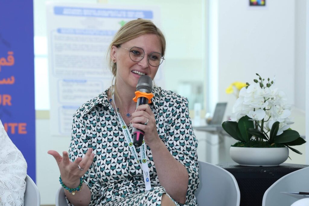 Sylvia Kluge, Head of Service Quality Operational Projects at Siemens Energy and a parent to a POD, speaking in a panel discussion on understanding different needs and support systems for employees who are parents of POD at Aurora50's Inclusive Workplaces Summit 2024 at Zayed Higher Organization in Abu Dhabi.