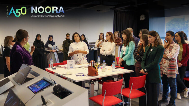 A photo from Aurora50's NOORA women's network (with logo) from a meet-up on 9 January 2025. The workshop focused on social capital and two male allies were invited to attend. In this photo, women gather during the workshop.