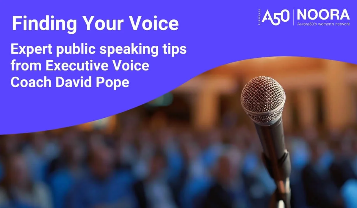 Blog post graphic shows Aurora50 and NOORA logos with strapline Aurora50's women's network, plus headline ‘Finding Your Voice: Expert public speaking tips from Executive Voice Coach David Pope’ and an image of a microphone in front of a large crowd.